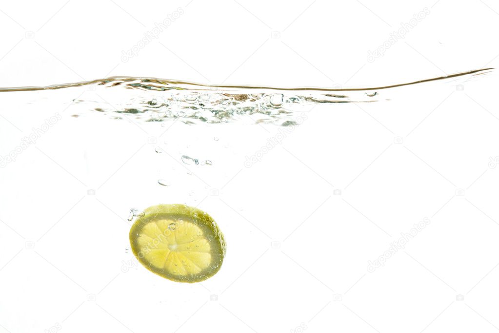 Fresh lemon dropped into water