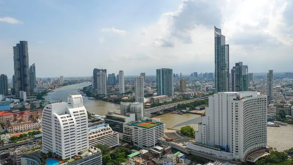 Bangkok city skyline view from river with skyscrapers buildings reflect in water at noon., Beautiful panoramic city skyline., cityscape view from high above.