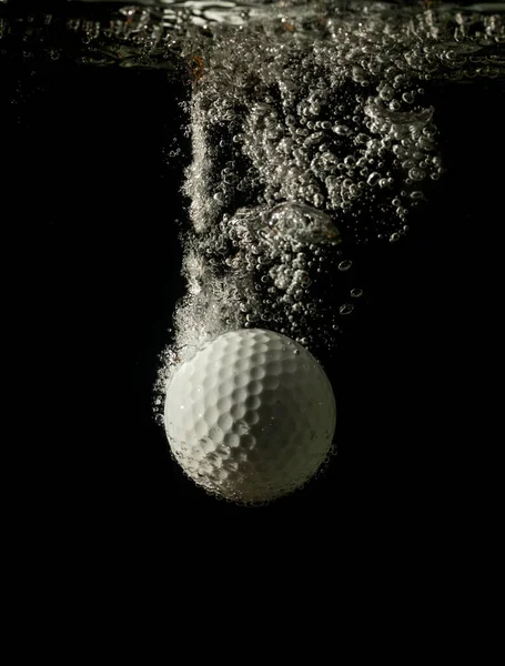 Egy Fehér Golflabda Beleesik Vízbe Elszigetelve Feketétől — Stock Fotó