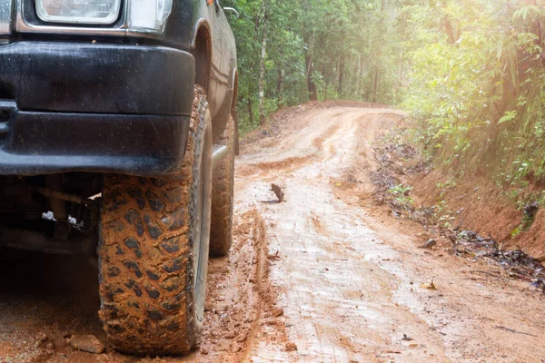 Muddy off-road vehicles, off road trip on mountain road sunset beautiful nature