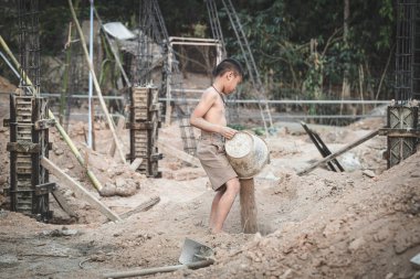 Children working at construction site. Concept against child labor and human trafficking for world day against child labor concept.