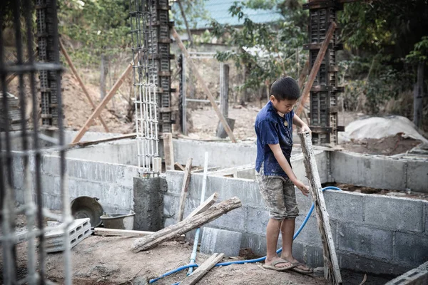 Children working at construction site. Concept against child labor and human trafficking for world day against child labor concept.