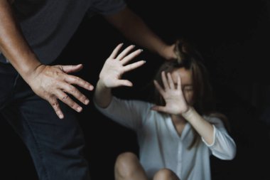 man are using force to coerce woman. scared woman lift hand up for say stop, to protect herself. stop domestic violence against women and anti human trafficking campaign, rape.