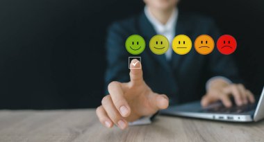 customer services best, Hand of a businessman chooses a smiley face.  excellent business rating experience. Satisfaction survey concept. maximum satisfaction.