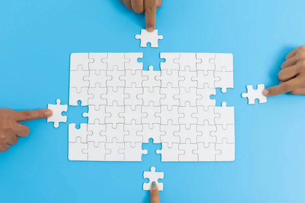 Jigsaw connection, Jigsaw puzzle in the hand of a businessman,  Business team assembling Jigsaw puzzle.