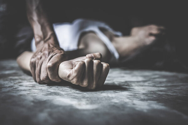 Close up of man hands holding a woman hands for rape and sexual abuse, anti trafficking and stopping violence against women, International Women's Day