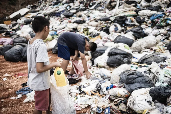 一个贫穷的印度小男孩把塑料瓶子装进了他的口袋 以赚取生计 贩运人口 — 图库照片