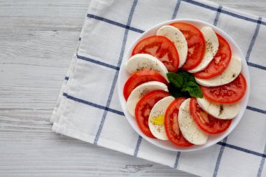 Mozzarella, Domates ve Basil soslu ev yapımı Caprese Salatası. Dümdüz, tepeden, yukarıdan. Metin için boşluk.