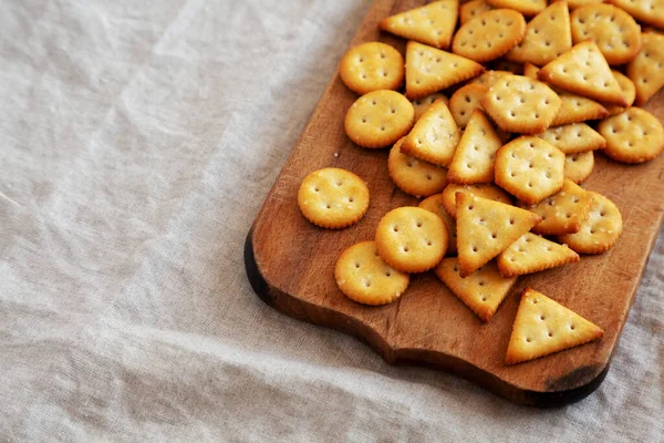 Ev yapımı tuzlu krakerler, kırsal ahşap tahta üzerinde, alçak açılı. Metin için boşluk.
