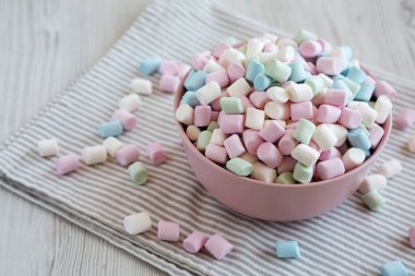 Pembe kâse içinde Gökkuşağı Fruity Mini Marshmallowları, yan görüş. Boşluğu kopyala.