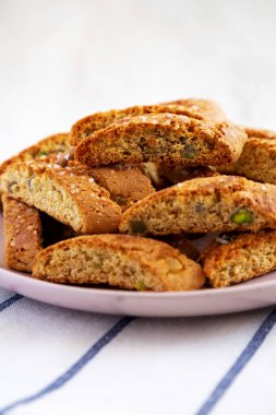 Ev yapımı İtalyan Cantuccini, yanında da Pistachios ve Citron tabağı. Çıtır Pistachio ve Citron Kurabiyeleri. Yakın plan..