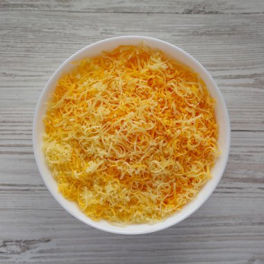 Beyaz kasede doğranmış Meksika peyniri karışımı. Manzaralı. Dümdüz, tepeden, yukarıdan. 