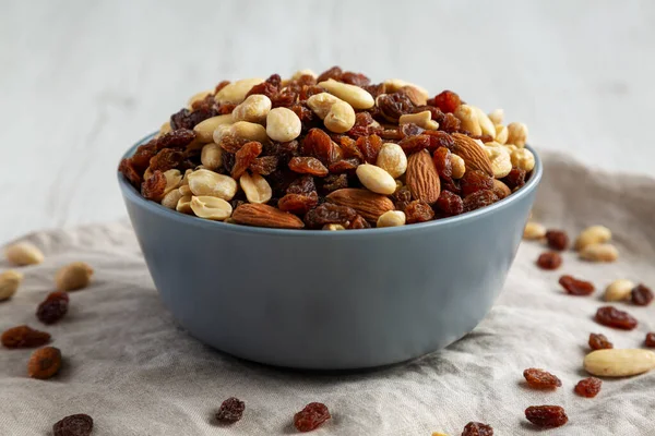 Raw Trail Mix with Nuts and Fruits in a Bowl, side view. Close-up.
