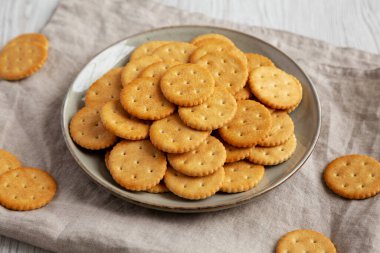Salty Round Crackers on a Plate, side view.
