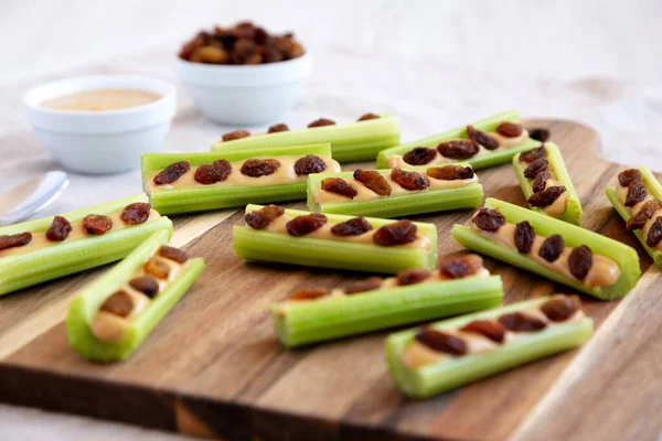 Homemade Ants Log Celery Peanut Butter Raisins Wooden Board Side — Fotografia de Stock