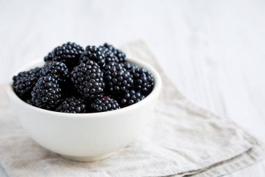 Raw Blackberries in a Bowl, side view. Space for text.