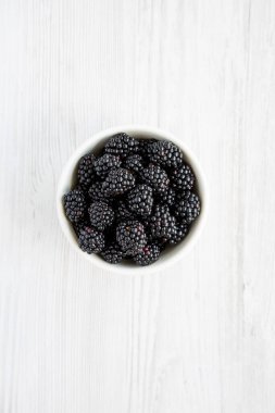 Raw Blackberries in a Bowl, top view. Flat lay, overhead, from above. 