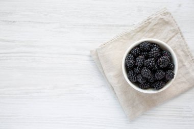 Raw Blackberries in a Bowl, top view. Flat lay, overhead, from above. Space for text.
