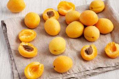 Raw White Apricot Angelcots on a white wooden background, low angle view. 