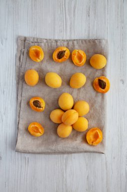 Raw White Apricot Angelcots on a white wooden background, top view. Flat lay, overhead, from above. 
