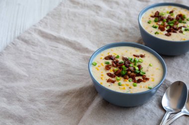 Homemade Corn Chowder with Bacon in Bowls, side view. Copy space.