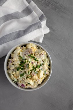 Homemade Healthy Potato Salad with Eggs in a Bowl on a gray background, top view. Flat lay, overhead, from above. Space for text.