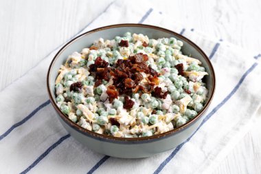 Homemade Creamy Bacon Pea Salad in a Bowl, side view. Close-up.