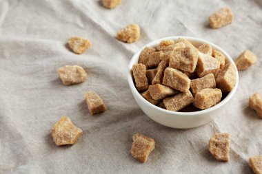 Raw Organic Demerara Granulated Brown Sugar in a Bowl, side view.