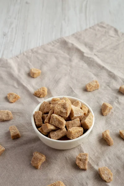 Raw Organic Demerara Granulated Brown Sugar in a Bowl, side view. Copy space.