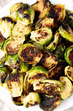 Homemade Roasted Brussel Sprouts on a Plate, top view. Flat lay, overhead, from above. Close-up.