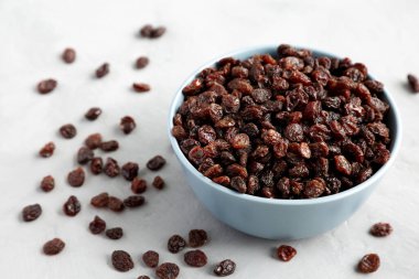 Dried Brown Raisins in a Bowl, low angle view.