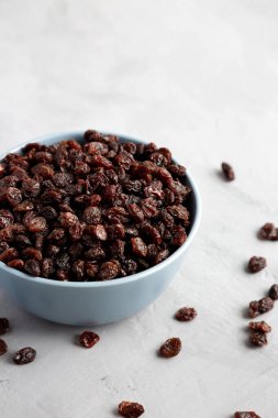 Dried Brown Raisins in a Bowl, side view. 