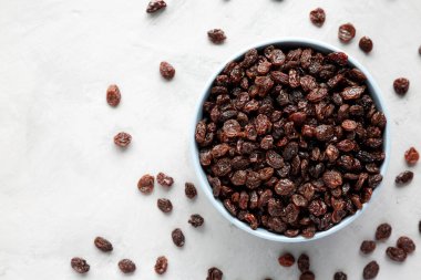 Dried Brown Raisins in a Bowl, top view. Flat lay, overhead, from above.