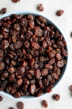 Dried Brown Raisins in a Bowl, top view. Flat lay, overhead, from above. Close-up.