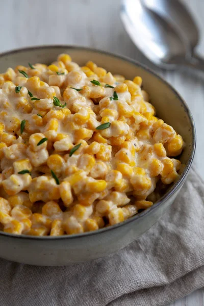 Homemade Slow Cooker Creamed Corn in a Bowl, side view. Close-up.