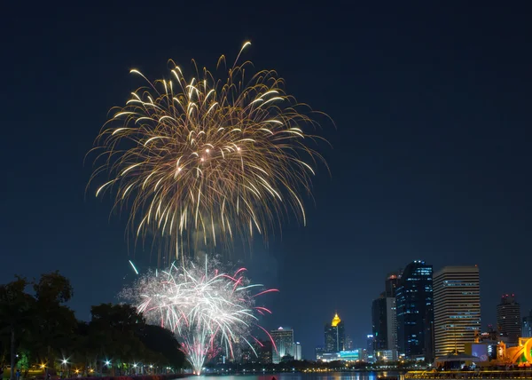 Colorful fireworks on the river and cityscape — Stock Photo, Image