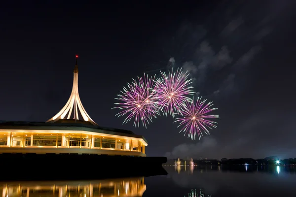 Colorful fireworks on the river and cityscape — Stock Photo, Image