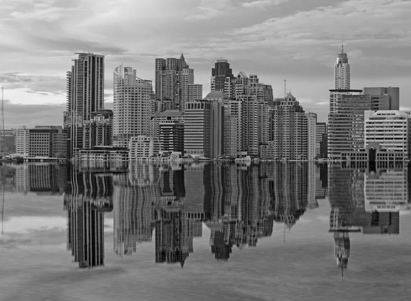 Building on Reflection on black and white scene at mid of city — Stock Photo, Image