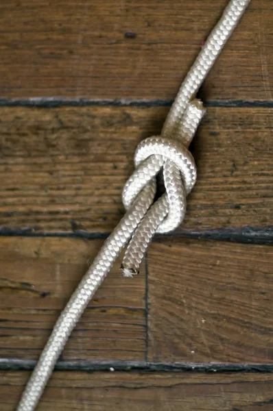 Reef knot over the wooden background — Stock Photo, Image