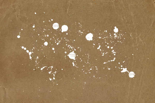 Old paper background with white paint splatter — Stock Photo, Image