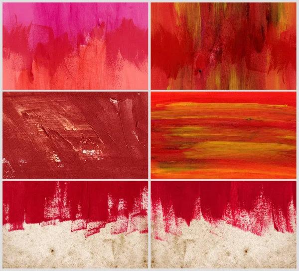 A set of hand painted red backgrounds daubs and brush strokes over old vintage paper - canvas — Stock Photo, Image