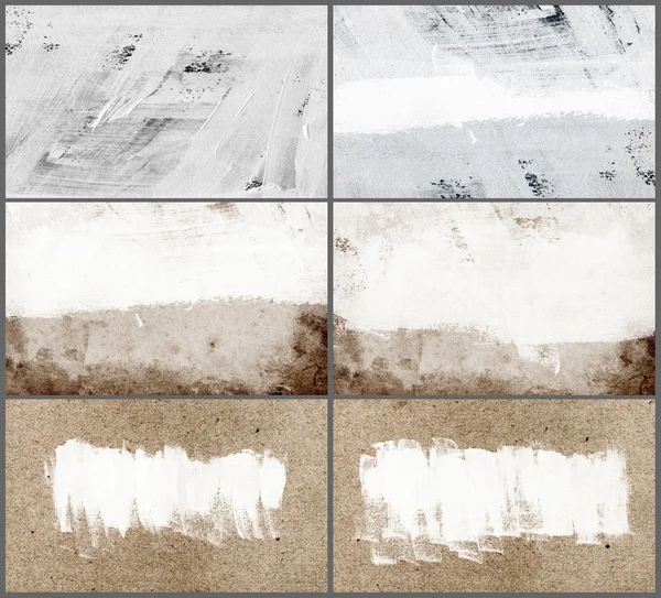 A set of hand painted white backgrounds daubs and brush strokes over old vintage paper - canvas — Stock Photo, Image