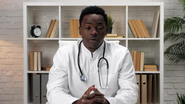 Africano americano homem online médico cumprimenta conversando com paciente chamada de vídeo remoto — Vídeo de Stock