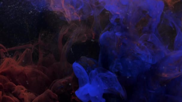 Amazing blue and red ink acrylic mixing in water, swirling softly underwater — Stock Video