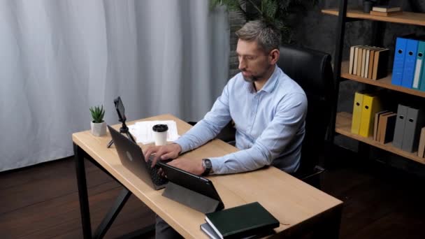 Adam borsacı simsar işadamı ofiste klavyede dizüstü bilgisayarda daktilo kullanıyor. — Stok video