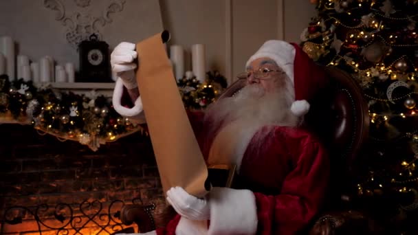 Santa Claus reading letter with list gifts from children for Christmas holidays — Stock Video