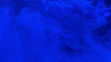 Mavi mürekkep akrilik boya suya düşer ve karışır, suyun altında yavaşça döner.