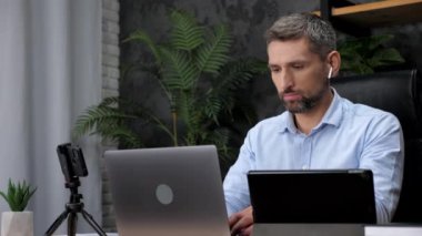 Businessman blogger distance works for laptop typing text on keyboard in office
