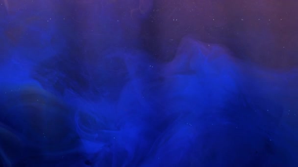 Blue and orange ink acrylic paint mixing in water, swirling softly underwater — Stock Video