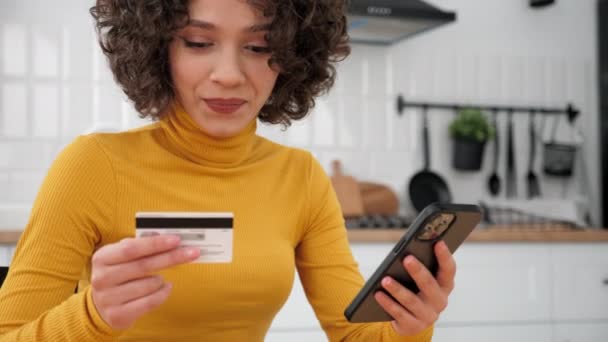 Close up woman enters credit card code to pay gifts, online shopping smartphone — Video